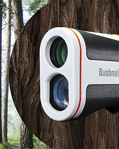 Bushnell rangefinder attached to a tree in a forest setting