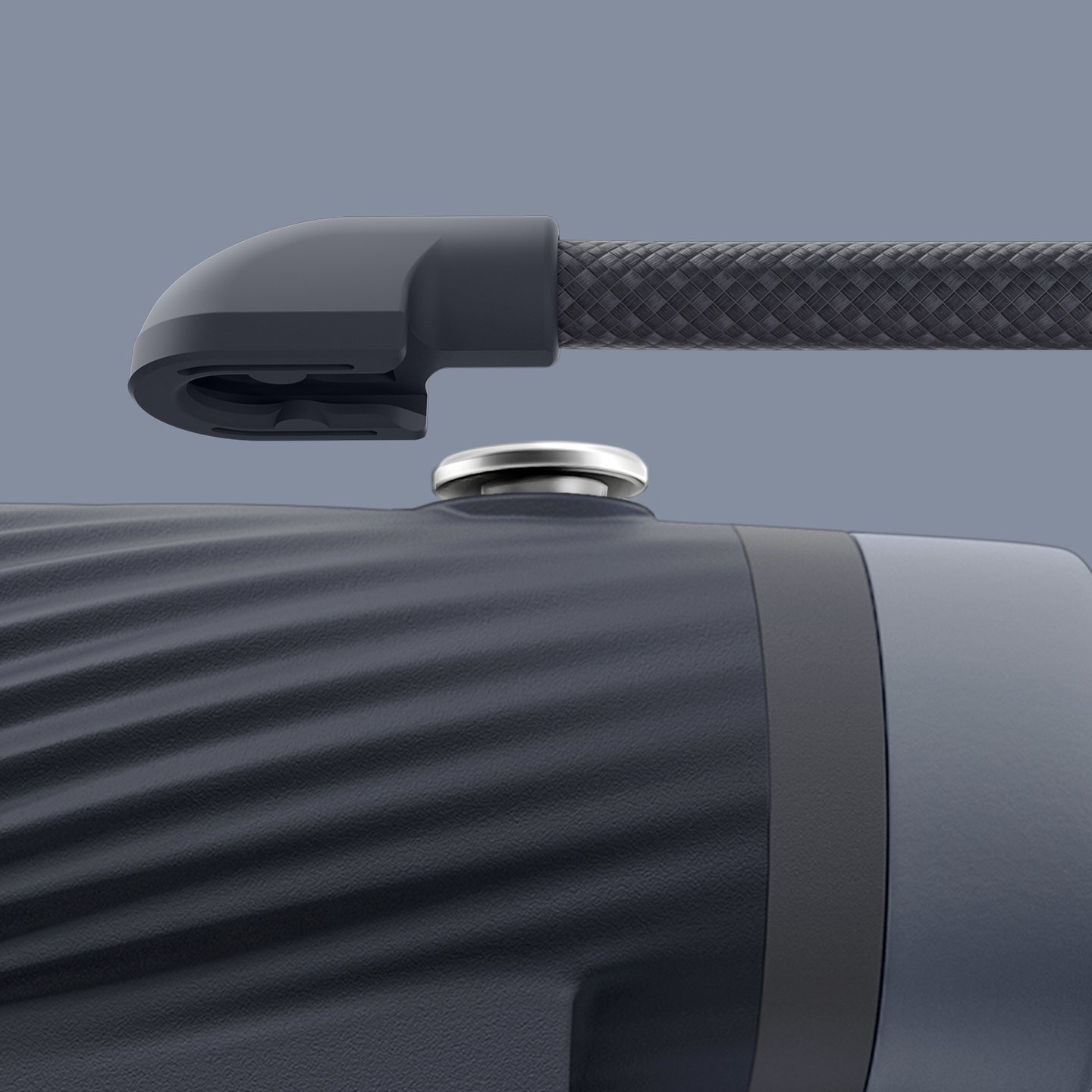 Close-up of detachable neck strap with a textured grip on a gray background