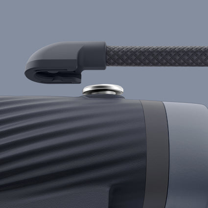 Close-up of detachable neck strap with a textured grip on a gray background