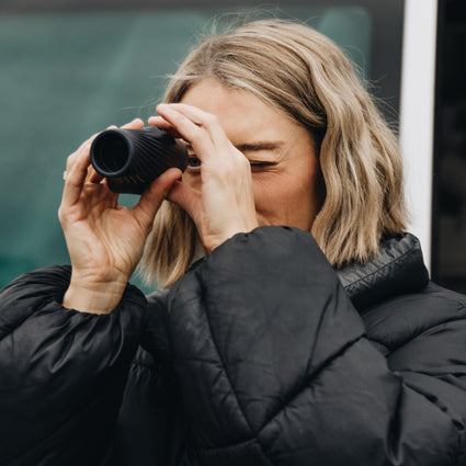 Person using Bushnell A3 monocular with a blurred background