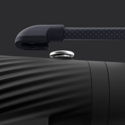 Close-up of a black detachable lanyard on a dark background