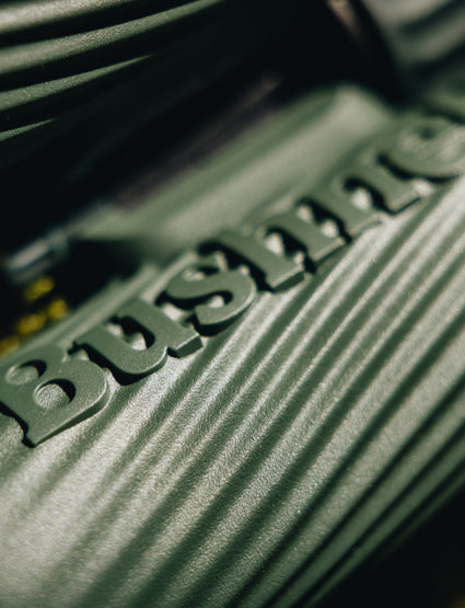 Close-up of a green metal object with 'Bussmann' branding.