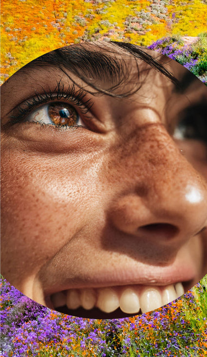 Close-up of a person's face with a colorful floral background