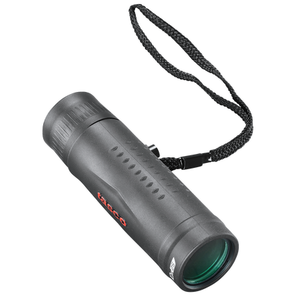 Front right view of a black monocular with red Tasco logo and black wrist strap on a transparent background